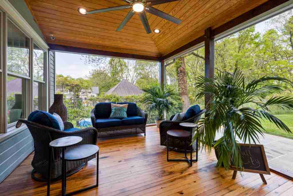 A beautiful patio extension with wood floors and ceiling and lighting and a ceiling fan