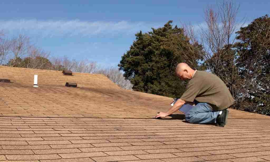 Roof Inspector Checking Out a Residential Home Roof for Damage in Texas